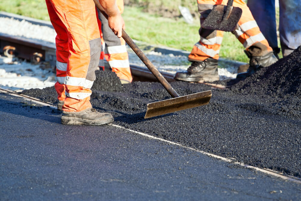 Why is asphalt used to make a road surface?